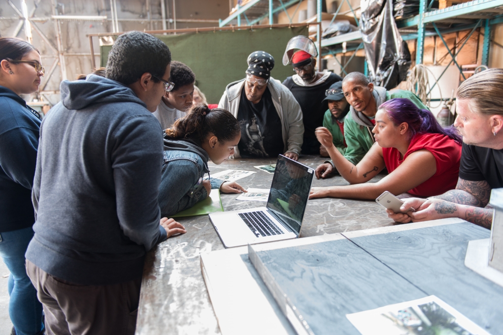 Weld to Work program participants discussing the design with students. Photo by Julie Brigidi, Oggi Photography