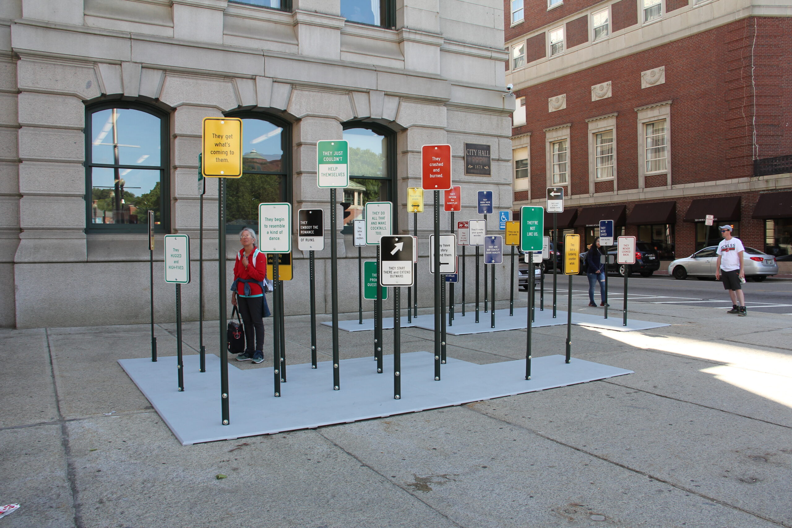 photo of an art installation of street signs in front of city hall