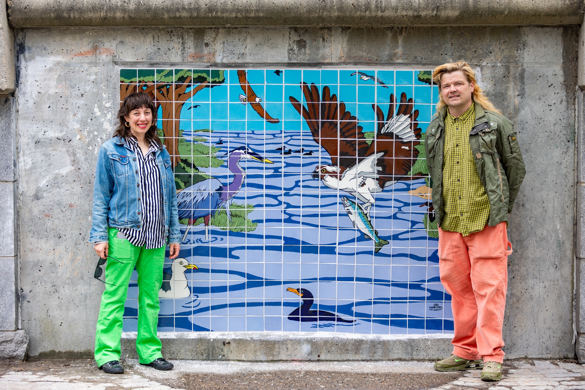 photo of artists in front of their artwork