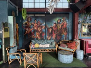The painted mural blinds at Troop hide acoustic window voids, which absorb sounds that would otherwise bounce around the space and create an unfocused ambience.