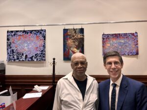 Painter Bob Dilworth and Mayor Smiley pose in front of Bob's paintings